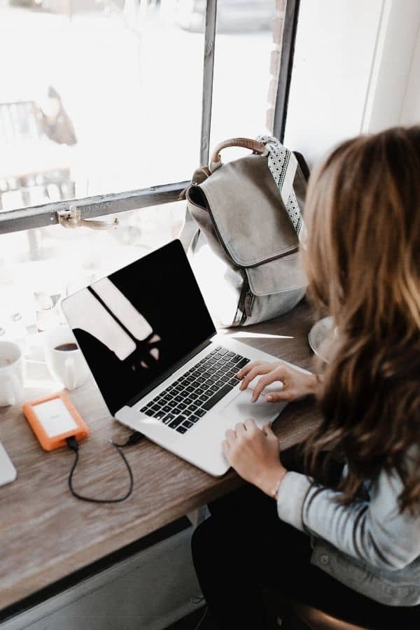 woman writing on laptop remote writing jobs from home